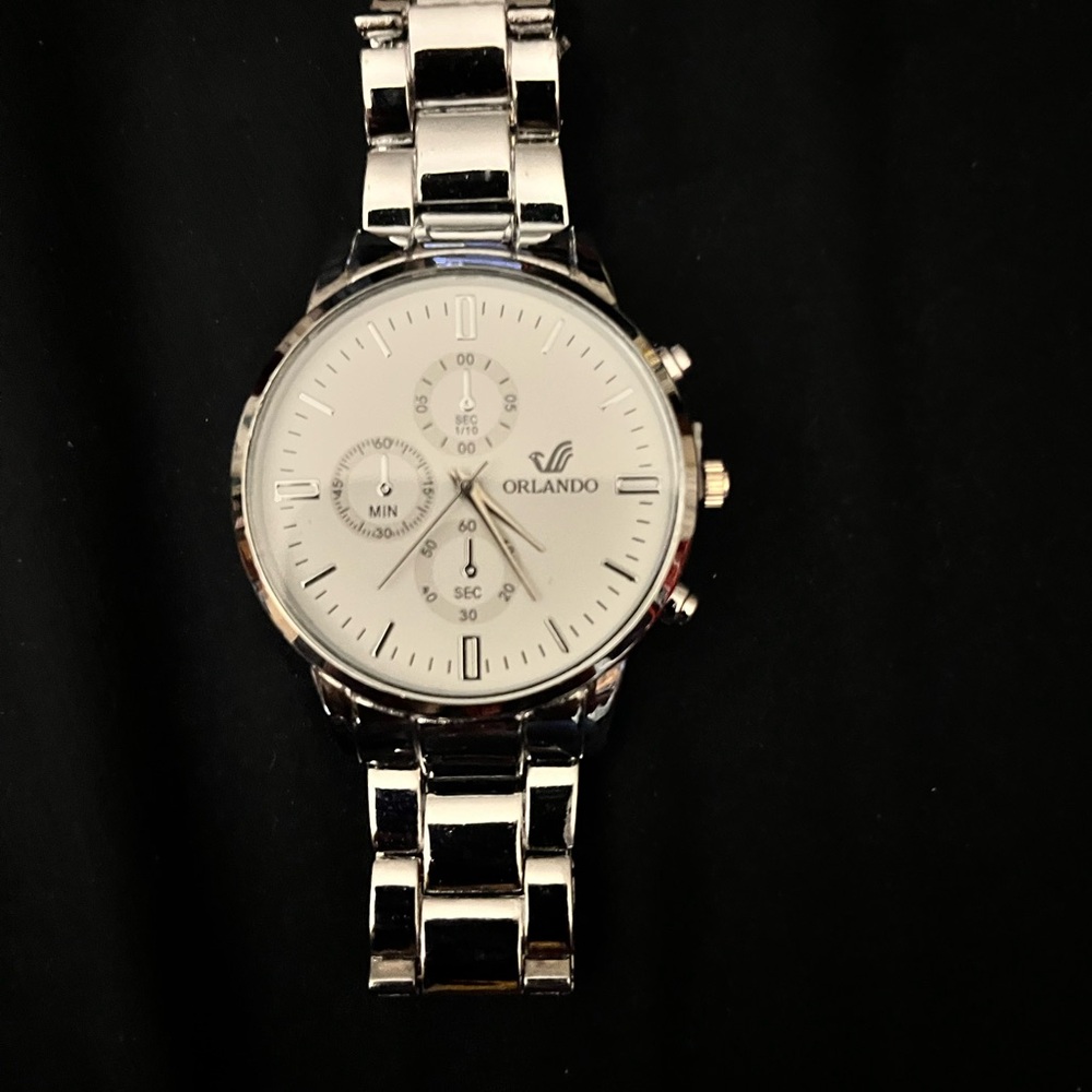 Stainless Steel watch, white face, second hand.